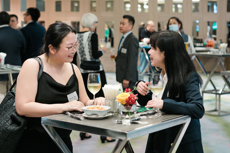 Singapore event with 2 people talking at a table