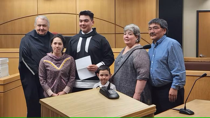 James Takkiruq, centre, with his son and family, as well as Nunavut Chief Justice Neil Sharkey, left, after being called to the Nunavut bar. (Submitted by Jessica Shabtai)