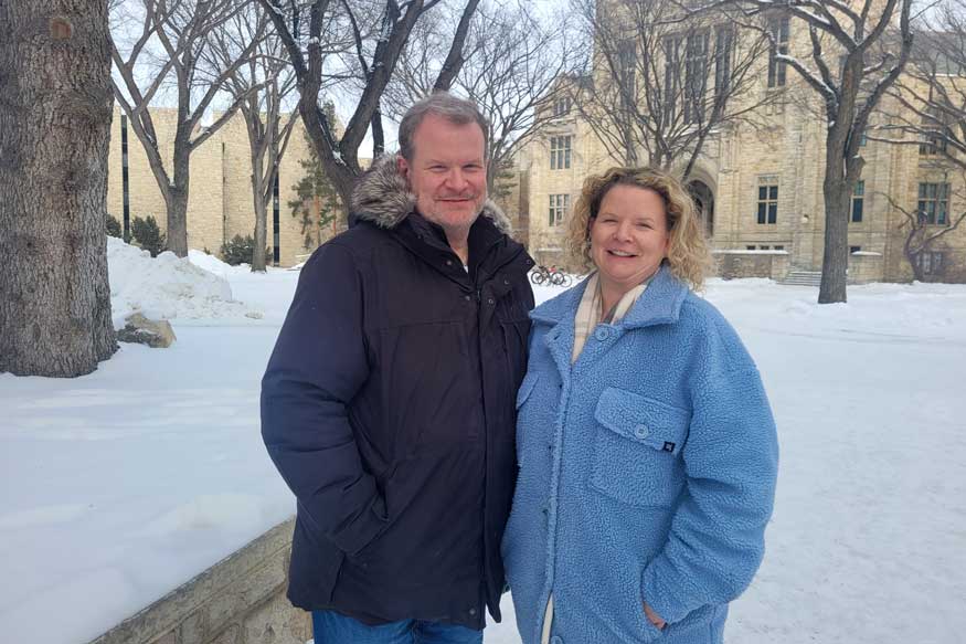 Siblings, Tyler Moss and Tannis Nicholson stand outside on the USask campus in the winter