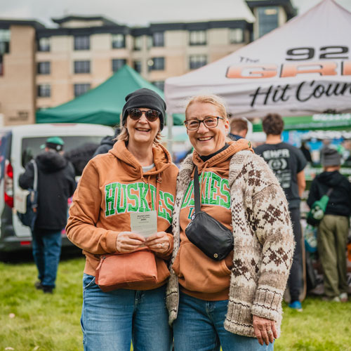 Two women in USask clothing at Rally Alley