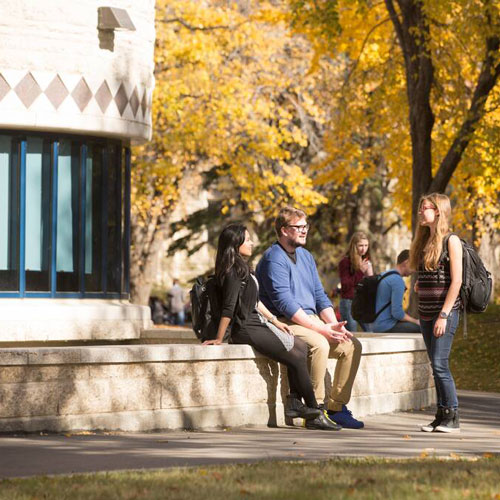 Students talking outside the Gordon Oakes Red Bear Student Centre on USask campus